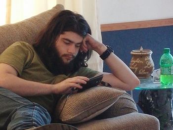 Midsection of young woman sitting at home