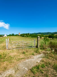 Scenic view of field against blue sky