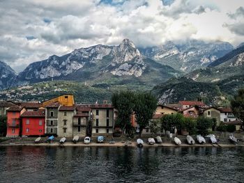 Townscape by river against sky in town