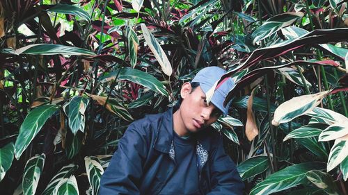 Portrait of young man against plants