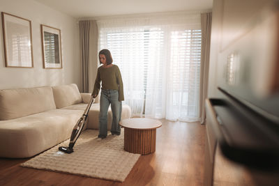 Rear view of man sitting in room