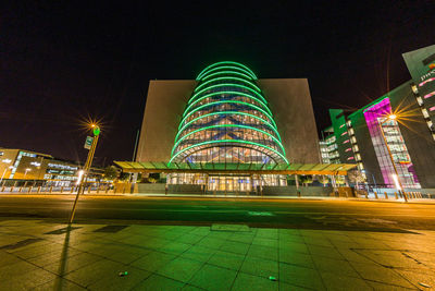 Illuminated modern building against sky at night