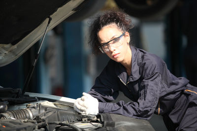 Portrait of female mechanic at garage