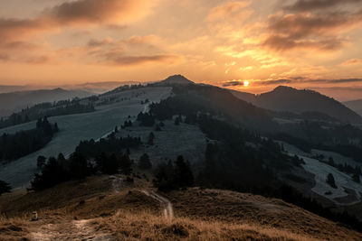 Scenic view of mountains against sky during sunset