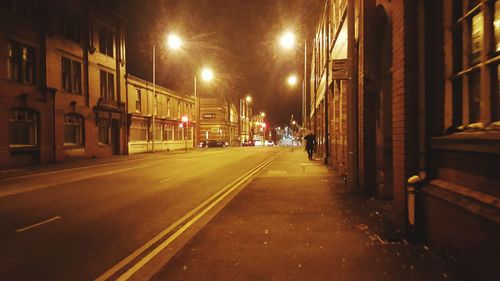 Illuminated street lights in city at night