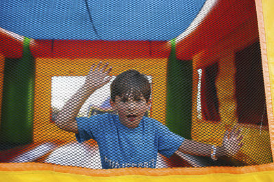 Portrait of boy standing in trampoline