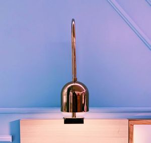 Close-up of electric lamp on table against wall