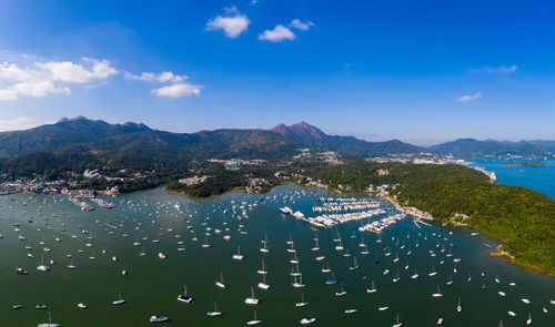 High angle view of city by sea against sky