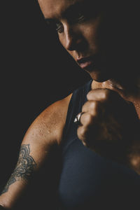 Close-up of young man against black background