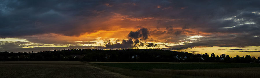 Scenic view of landscape against cloudy sky
