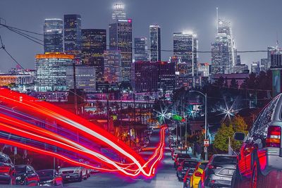 Light trails on city against sky