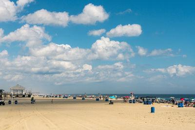 People at beach against sky