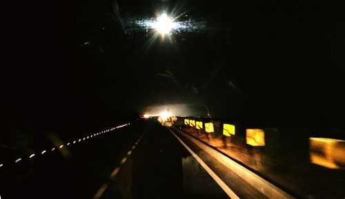 Illuminated tunnel at night