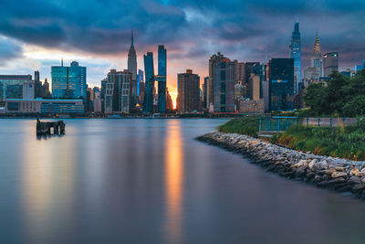 View of city at waterfront at sunset