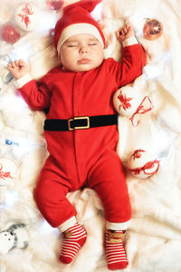 High angle view of cute baby sleeping on bed