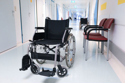 Wheelchair in an empty hospital corridor, close up. medical healthcare concept