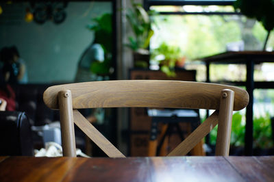 Close-up of empty chairs and table in cafe