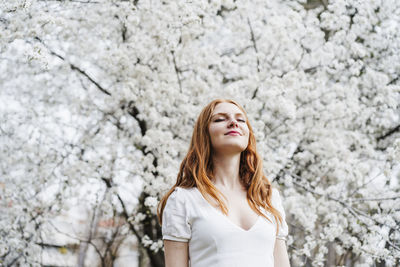 Portrait of young woman with cherry blossom