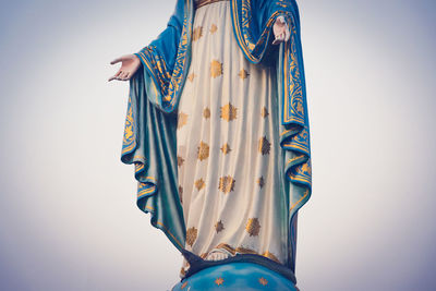 Close-up of woman against blue background