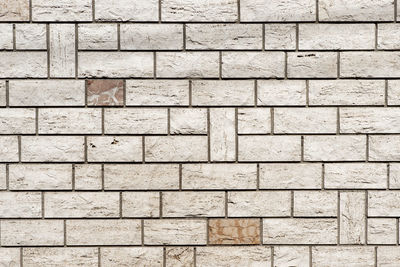 Real wall made of light grey brick background textured