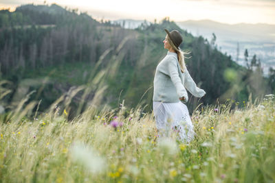 Young woman standing on field