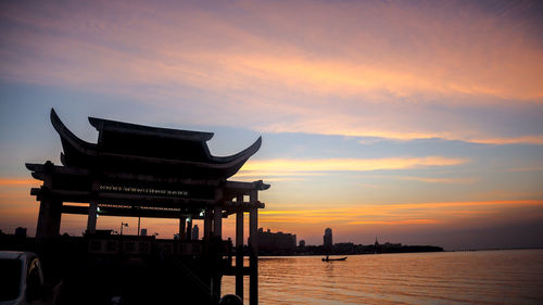 Silhouette building against sky during sunset