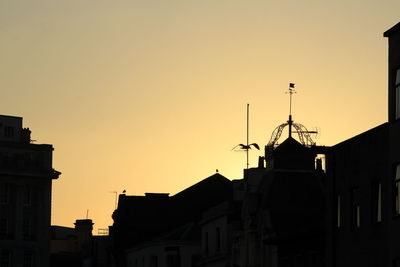 Low angle view of building against sky at sunset