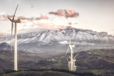 Global warming, climate change. turbines on the field on the sunset sky. alternative energy source