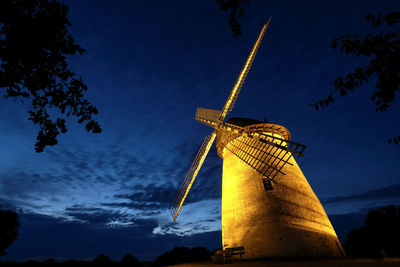 Low angle view of traditional windmill against sky