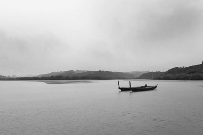 Scenic view of boat in sea against sky