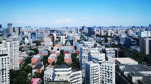 High angle view of buildings in city against sky