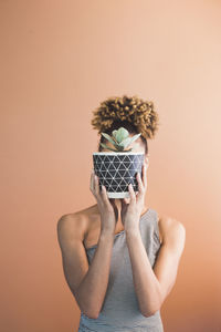 Portrait of man wearing mask against white background