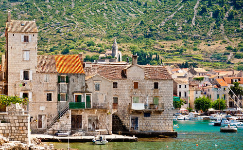 Old stone houses in the port of komiza, island vis, croatia.
