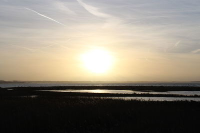 Scenic view of beach against sky during sunset