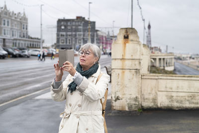 Woman photographing with cell phone