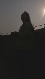 Low angle view of silhouette woman against clear sky