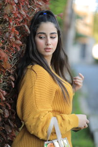 Young woman with yellow hair standing outdoors