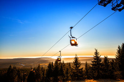 Overhead cable car against sky during winter