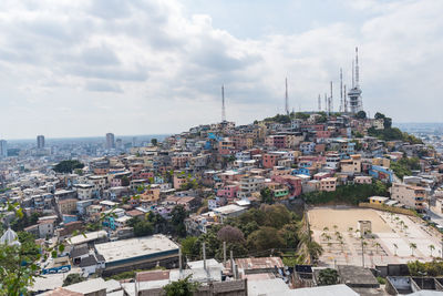 Cityscape by sea against sky
