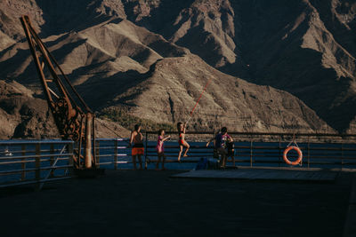 Rear view of people on mountain range