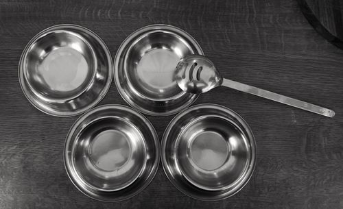 Directly above shot of metal bowls on wooden table