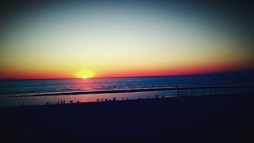 Scenic view of sea against clear sky at sunset