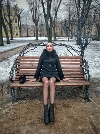 Woman sitting on tree stump