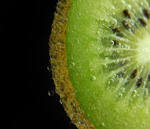 Close-up of fruit on water against black background