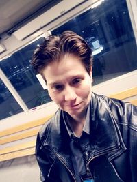 Portrait of teenage girl looking through window