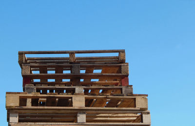 Low angle view of building against clear blue sky