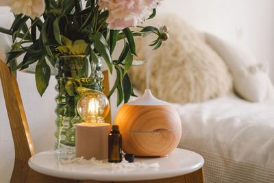 Aroma oil diffuser on chair against in the bedroom. air freshener.