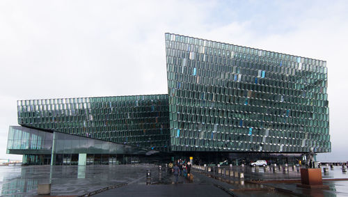 View of modern building against cloudy sky