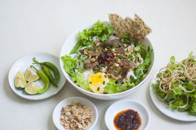 Vietnamese noodle - my quang, vietnamese traditional cuisine, noodles in bowl on the table 