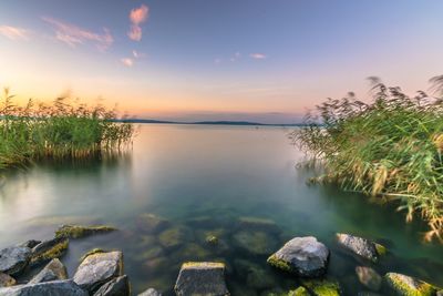 Scenic view of lake against sky during sunset
